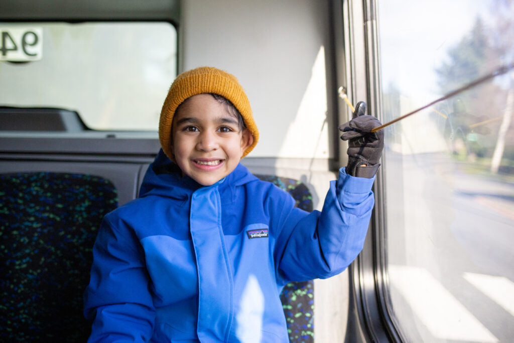 Happy little boy requesting to stop in a BC Transit bus.